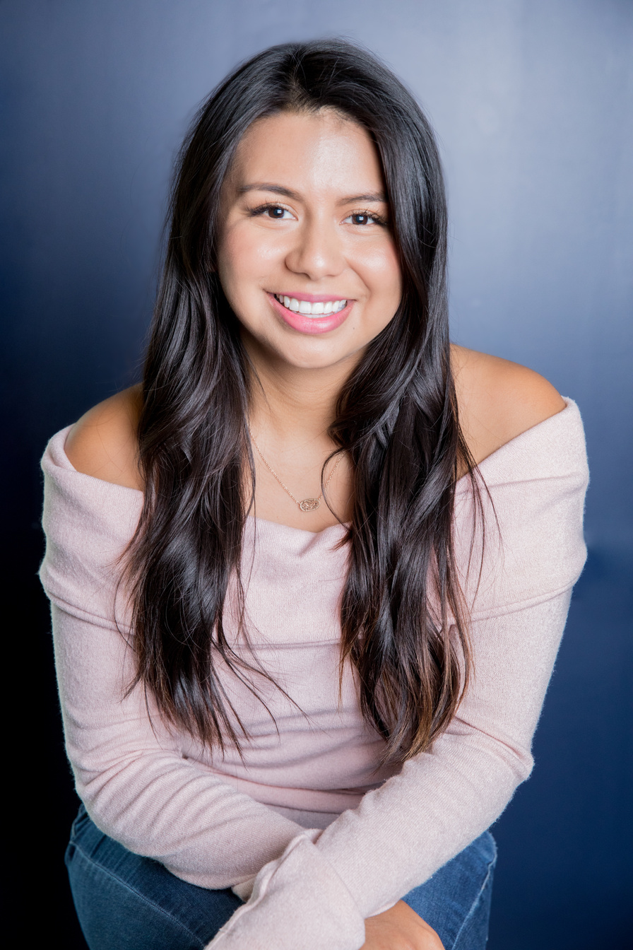 Hispanic woman smiles for professional head shot